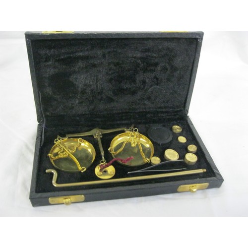 187 - Cased brass decorative balance scale with weights