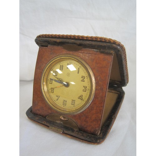 151 - A vintage Junghans travel alarm clock in folding leather case (a/f not running, inner back plate loo... 