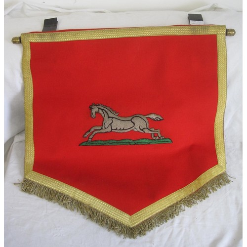 125 - A fabric banner of the Yorkshire Regiment embroidered with running horse. Red felt with gold-colour ... 