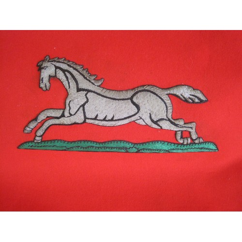 125 - A fabric banner of the Yorkshire Regiment embroidered with running horse. Red felt with gold-colour ... 