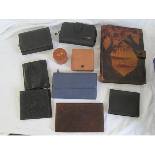 144 - Assorted purses and wallets, several in leather, a stud box, and a notebook with tooled leather cove... 