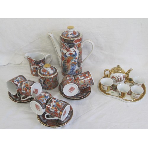 141 - A modern Japanese porcelain coffee set, decorated in traditional style with peacocks and gilding