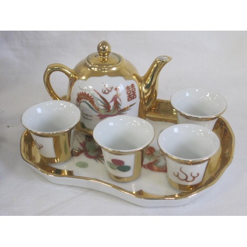 141 - A modern Japanese porcelain coffee set, decorated in traditional style with peacocks and gilding