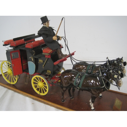 70 - A vintage model of an English Stage Coach and Horses in a perspex display mount with wooden base, in... 