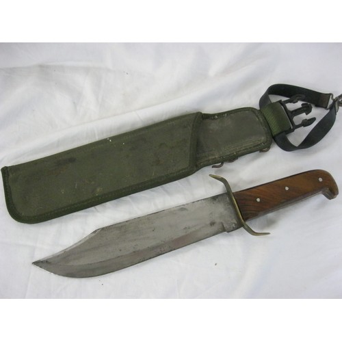 204 - A very large Bowie knife of some age in a webbing sheath, 10