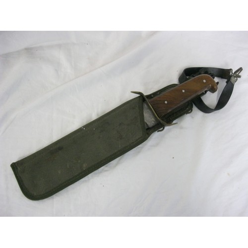 204 - A very large Bowie knife of some age in a webbing sheath, 10