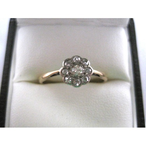 2 - An antique daisy design diamond cluster ring, the centre stone an old cut diamond surrounded by eigh... 