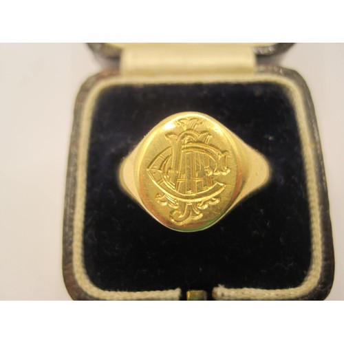 3 - An 18 carat gold gent's signet ring, oval shape with engraved interlinked initials on top. Hallmarke... 