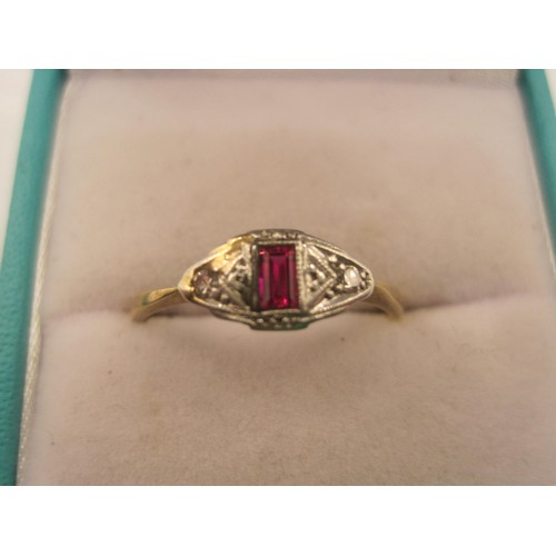 7 - An antique Art Deco style yellow metal diamond and ruby ring, the rectangle shaped ruby to the centr... 