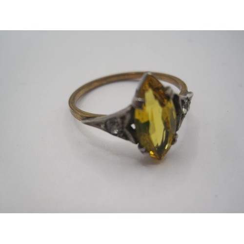 15 - A dress ring set with a marquise cut yellow stone to the centre (might be glass) with a small white ... 