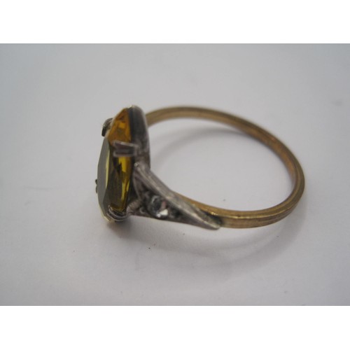 15 - A dress ring set with a marquise cut yellow stone to the centre (might be glass) with a small white ... 