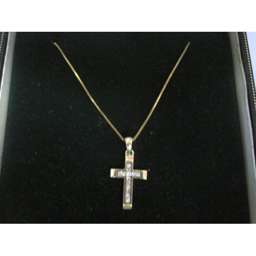 17 - A 9 carat imported gold cross pendant set with thirteen small channel-set brilliant cut diamonds, an... 