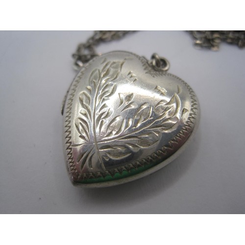 21 - A heart-shaped locket with foliate engraving to one side, stamped solid silver, with trace chain sta... 