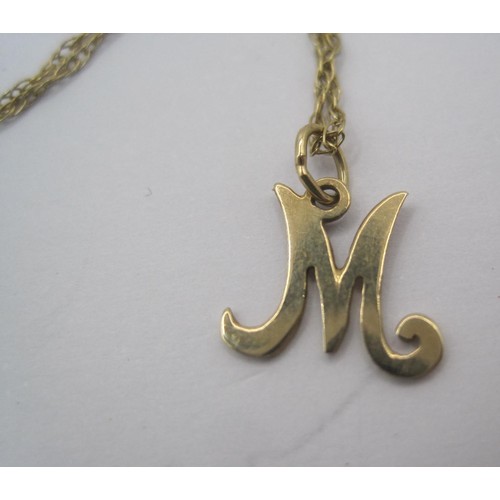 33 - A gold initial pendant 'M' on gold chain, stamped 375 9CT, approx. 1.1g. A pair of earrings stamped ... 