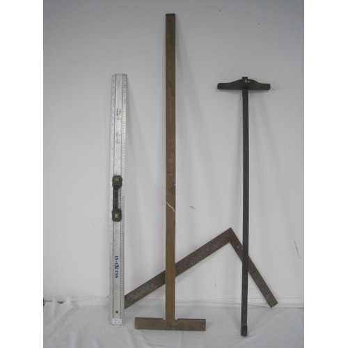 114 - A Rabone 48 inch wooden rule, a 1 meter aluminium rule with integral spirit level, an antique wooden... 