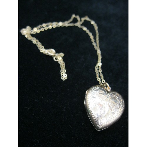 31 - A 9 carat heart-shaped locket approx 2.5cm in height with diamond cut foliate decoration to front an... 