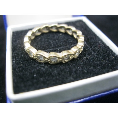 42 - A 9 carat gold eternity ring made of small, heart shaped links each containing a diamond, ring size ... 