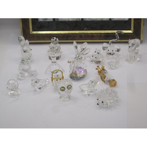 29 - Seventeen Swarovski crystal animals - squirrel, bird, frog, hedgehog, etc, with a display cabinet me... 