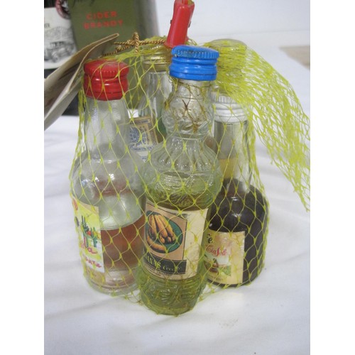 12 - A mixed alcohol lot. A Recuerdo de Espana tourist's net bag of seven alcohol miniatures (a/f storage... 