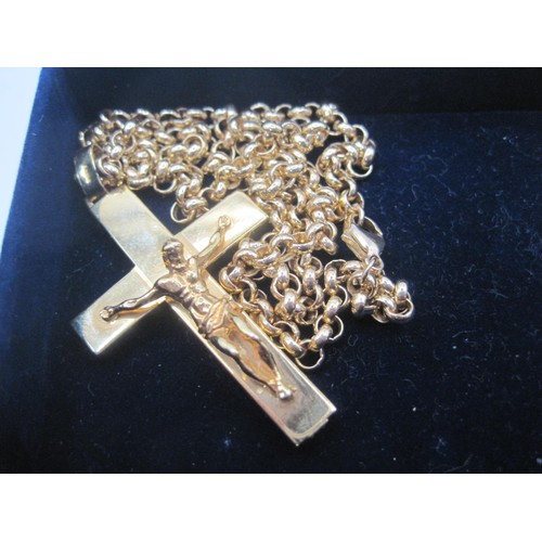 68 - A 9 carat gold crucifix with figural Christ on a heavy 9ct gold chain, crucifix measures 2