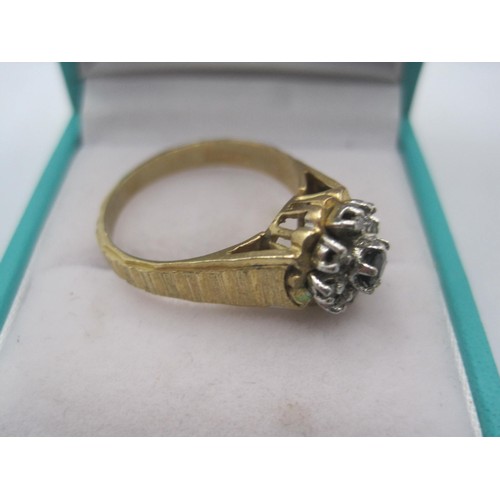 71 - A 9 carat gold ring set with a central sapphire surrounded by chip diamonds, size T, approx weight 4... 