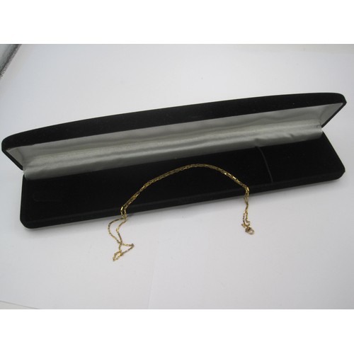 111 - A 9 carat gold chain, length about 45cm, stamped 375 and import marks, approx. 2g. With a black pres... 