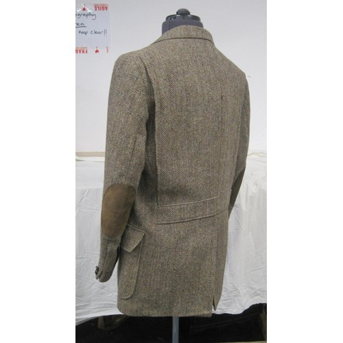 74 - A 100% Harris Tweed shooting jacket marked as size 42L in apparently unworn condition, no tags, plus... 