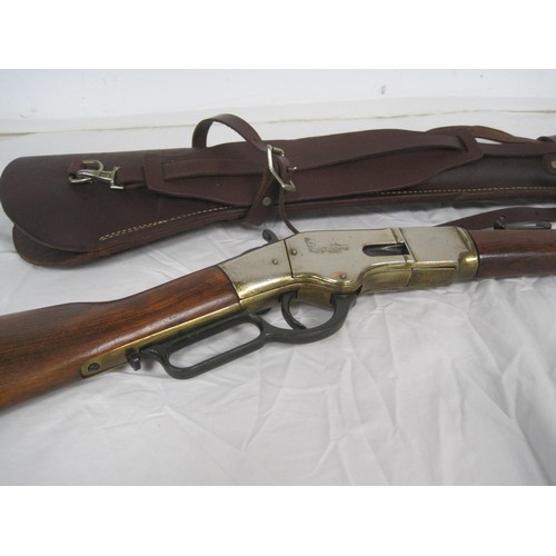 57 - A replica Winchester rifle with gold effect finish, brass butt plate and wooden stock, in a good qua... 