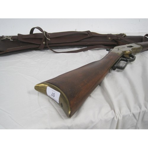 57 - A replica Winchester rifle with gold effect finish, brass butt plate and wooden stock, in a good qua... 