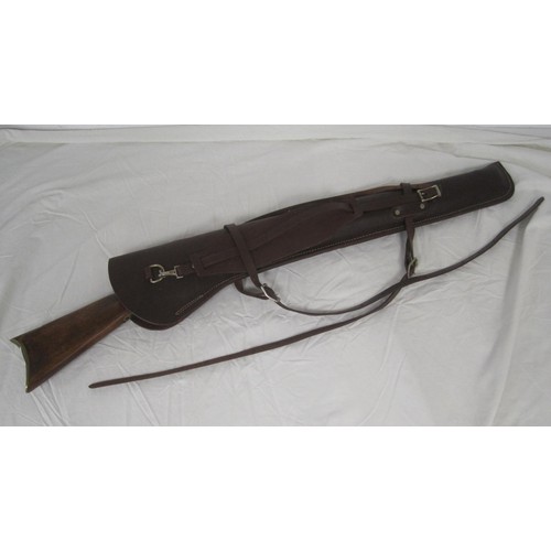 57 - A replica Winchester rifle with gold effect finish, brass butt plate and wooden stock, in a good qua... 