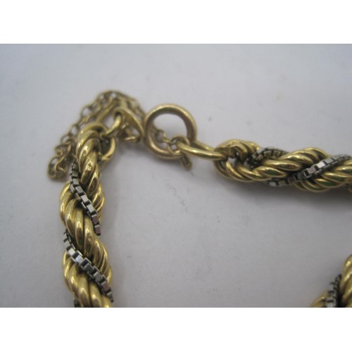 146 - Am imposing and eye-catching 18 carat gold bracelet comprising a yellow gold rope link with a white ... 