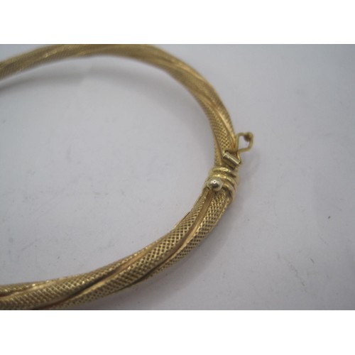 147 - A 9 carat gold bangle likely of middle-eastern origin, with safety clasp, hinged, in very good order... 