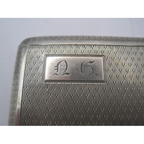 157 - A large sterling silver cigarette case with engine turned decoration to front and rear, in good orde... 