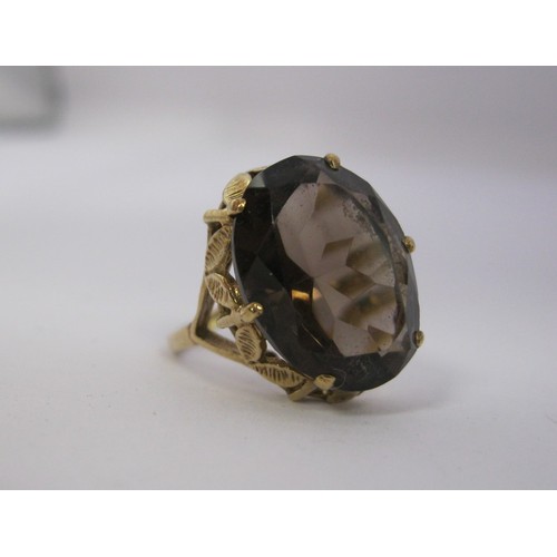 186 - A 9 carat gold ladies dress ring set with a large (about 15mm x 11mm) smoky colour faceted stone, Br... 