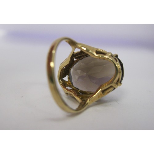 186 - A 9 carat gold ladies dress ring set with a large (about 15mm x 11mm) smoky colour faceted stone, Br... 