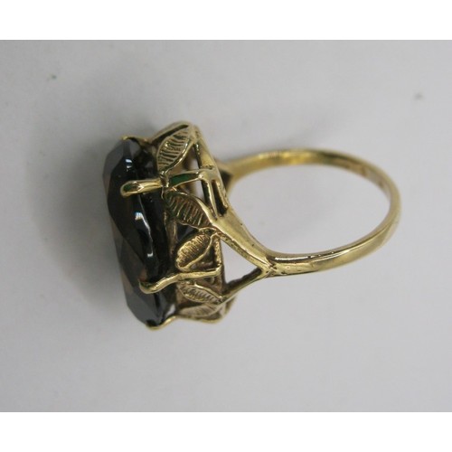 186 - A 9 carat gold ladies dress ring set with a large (about 15mm x 11mm) smoky colour faceted stone, Br... 