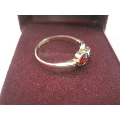 170 - A 9 carat gold ring set with three graduated rubies in a looped setting, ring size M, gross weight o... 