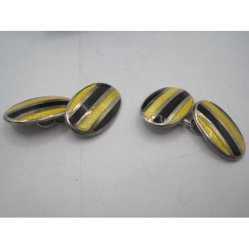 193 - A pair of silver cufflinks, cased, with black and yellow enamelled decoration, in good order