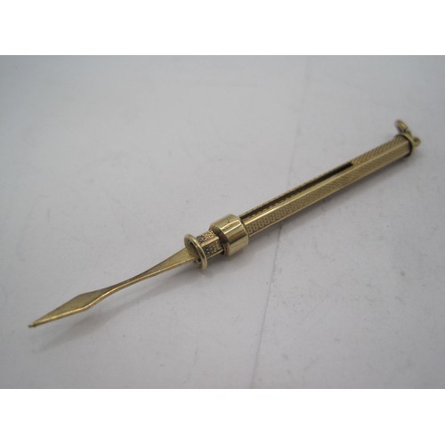 202 - A 9 carat gold toothpick, retracting, with engine turned finish and hoop mount, in outstanding order