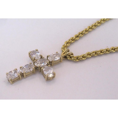 222 - A gold cross with white stones attached to a gold coloured chain.