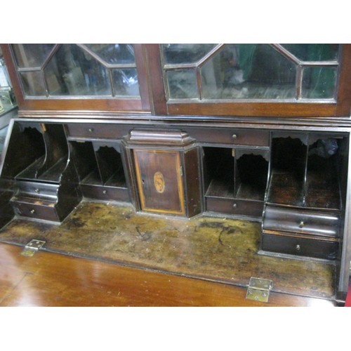 153 - A Georgian bureau with glazed bookcase over, the interior beautifully fitted with hidden compartment... 