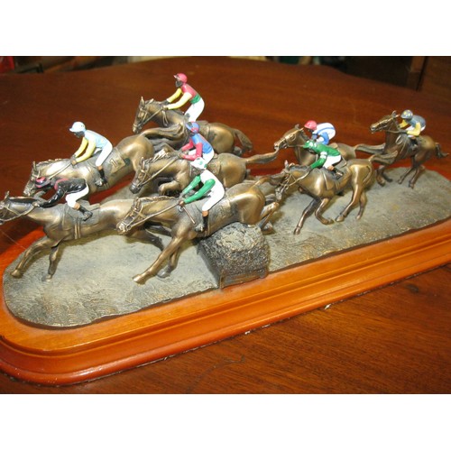 2 - A bronze tableau featuring racehorses and jockeys, brass plaque marked 'National Hunt number 434', i... 