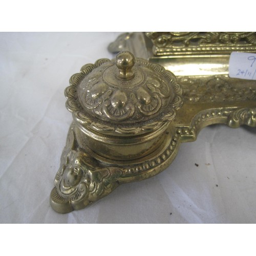 9 - An ornate brass desk stand with inkwell both containing brass inkpots