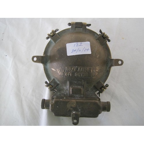 182 - A small brass marine bulkhead lamp with lens protector and integral switch, marked to rear BMAC LTD ... 