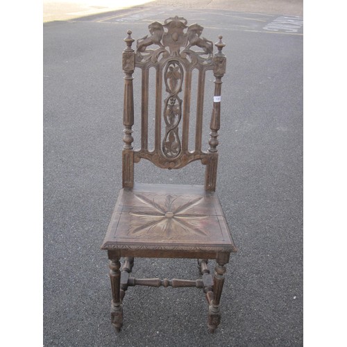 130 - An antique carved oak hall chair, height of backrail 113cm, carved with leaves, lions and shield. A/... 