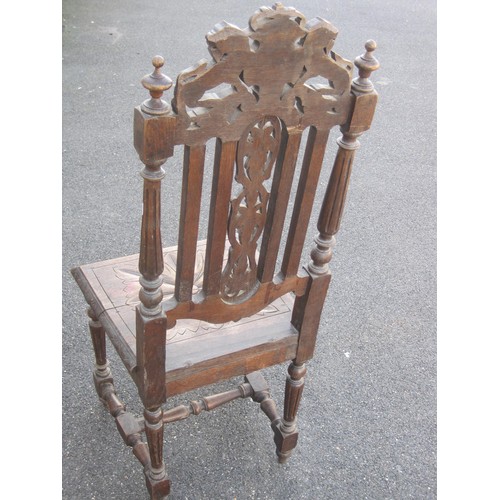 130 - An antique carved oak hall chair, height of backrail 113cm, carved with leaves, lions and shield. A/... 