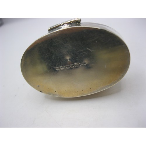 232 - A sterling silver snuff- or pill- box of oval form with repousse fairy decoration to lid, in good or... 