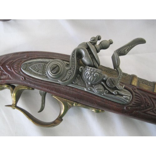 287 - A pair of heavy reproduction flintlock pistols in good order