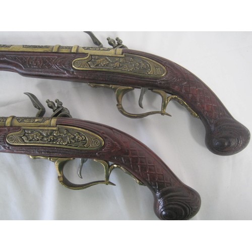 287 - A pair of heavy reproduction flintlock pistols in good order