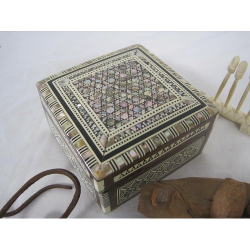 280 - A small, ornately inlaid box, 3 carved ethnic heads on a leather thong and a carved ethnic toothpick... 